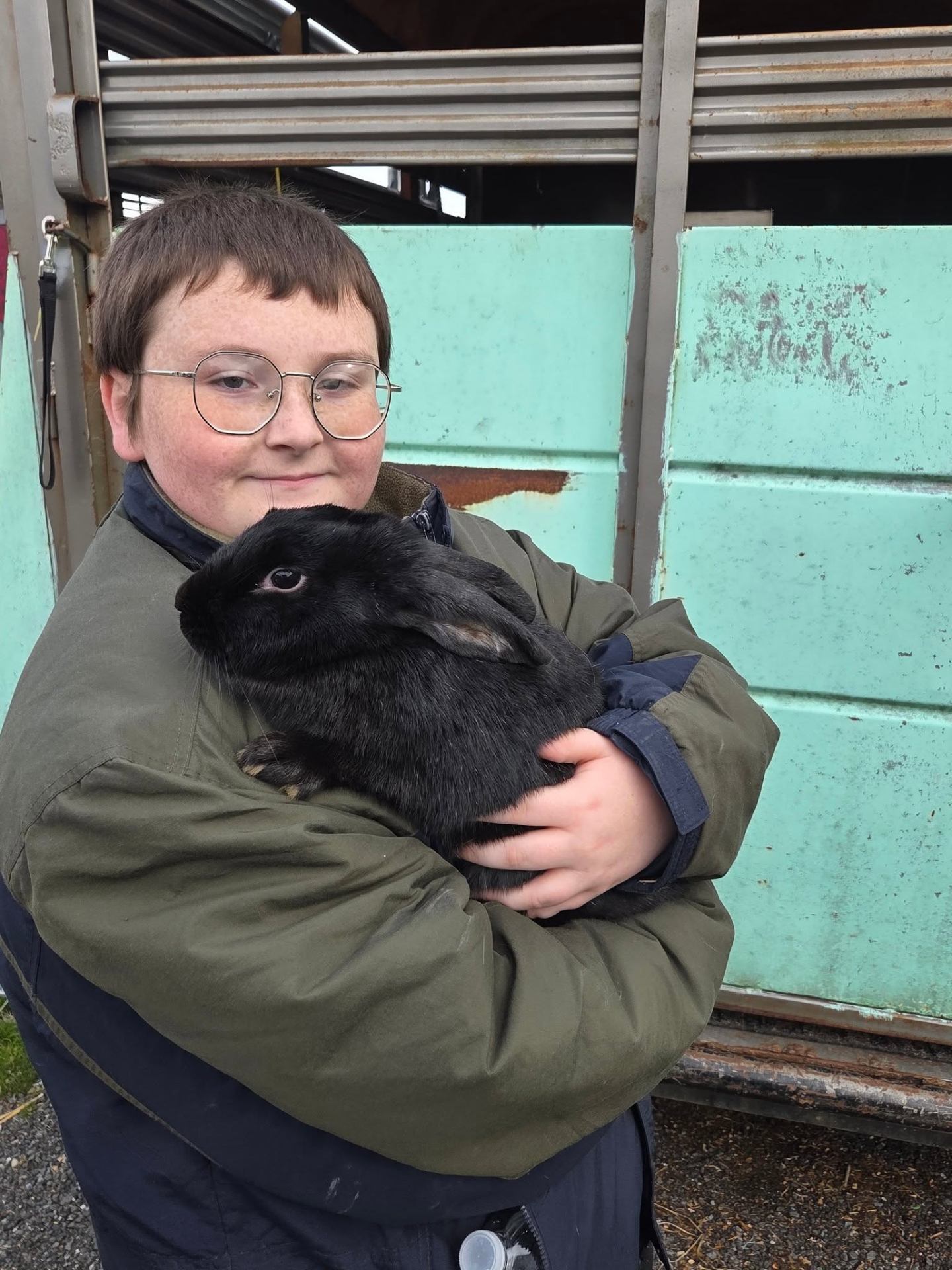 Gunner holding a black rabbit